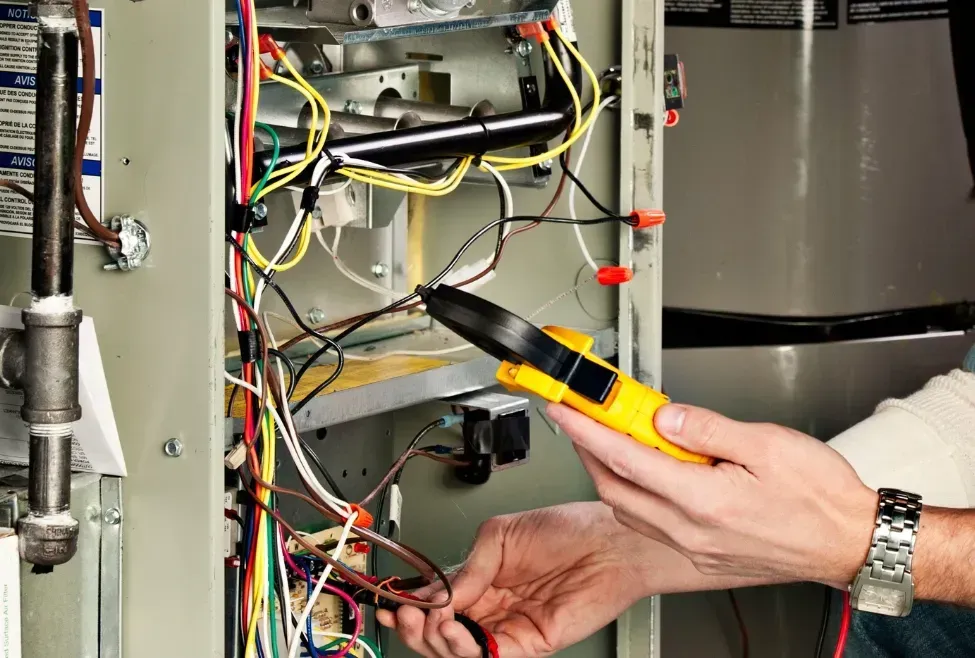 Technician repairing electrical panel wires