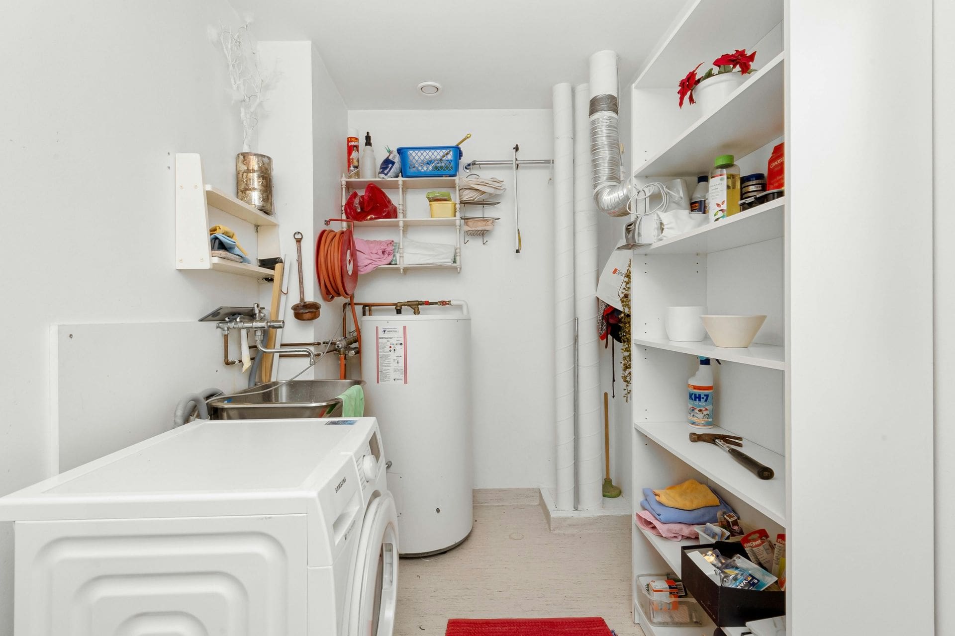 Organized utility room with washing machine
